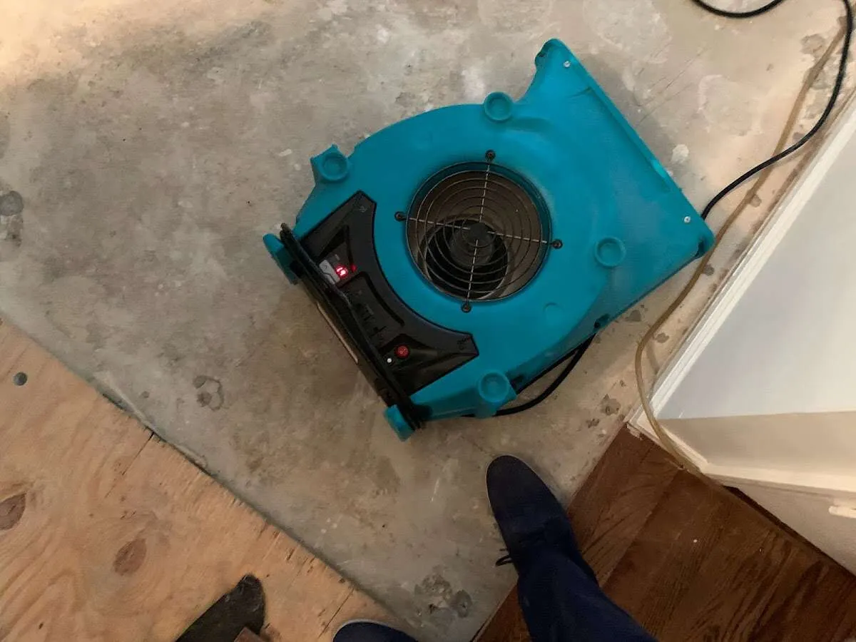 Air mover drying subfloor during Commercial Water Damage Restoration in Harrodsburg